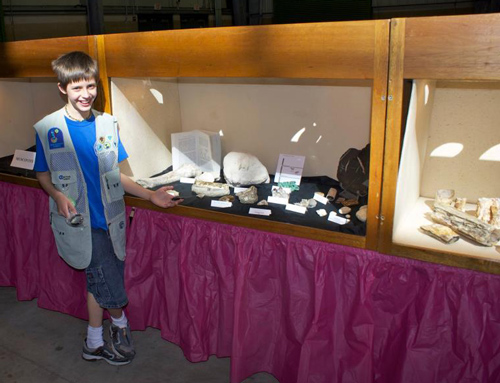 Proud junior rockhound showing off his exhibit